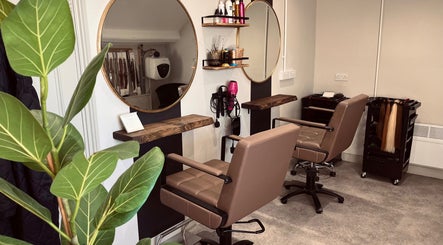 Modern salon interior at Rigs Wigs in Holywood, Northern Ireland, GB with stylish chairs and mirrors.