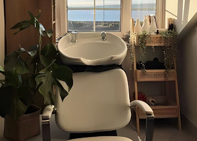 Relaxing salon space at Rigs Wigs, Holywood, Northern Ireland, GB with view of the sea.