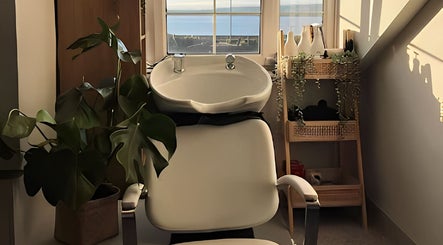 Relaxing salon space at Rigs Wigs, Holywood, Northern Ireland, GB with view of the sea.