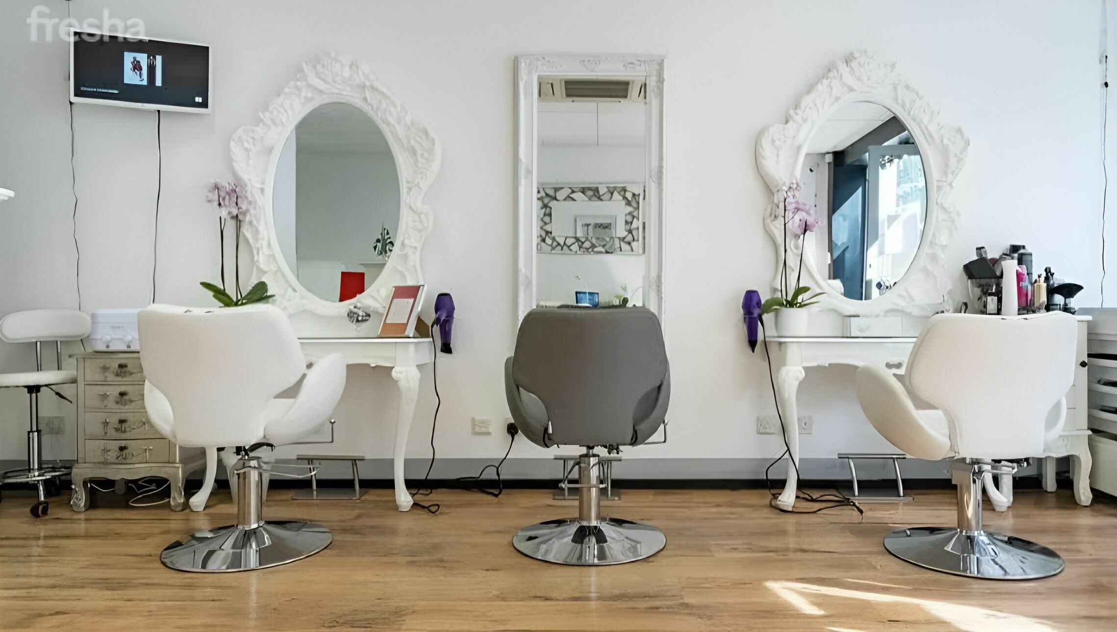 Elegant salon setup at Beauty by Fabi, Camberley, England, GB featuring modern chairs and ornate mirrors.