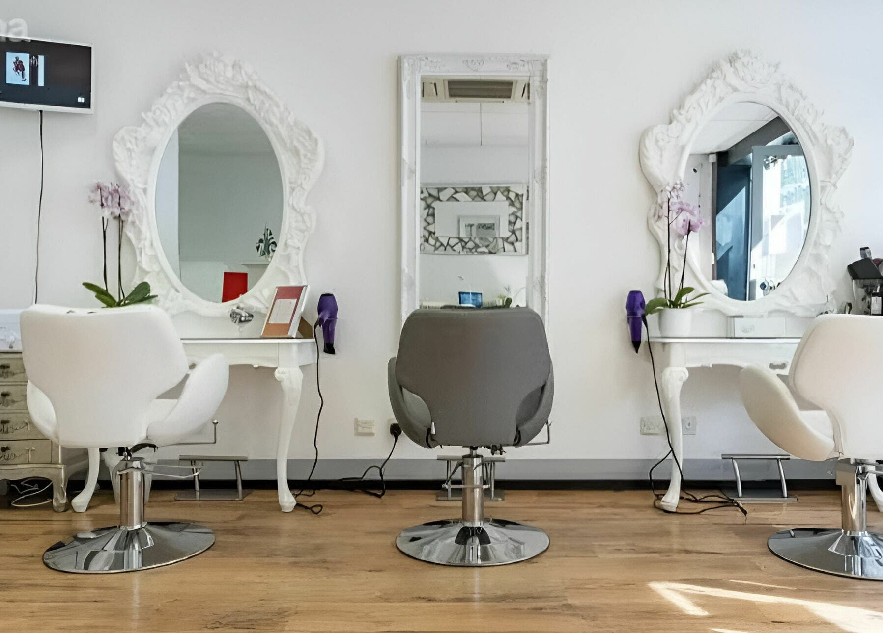 Elegant salon setup at Beauty by Fabi, Camberley, England, GB featuring modern chairs and ornate mirrors.