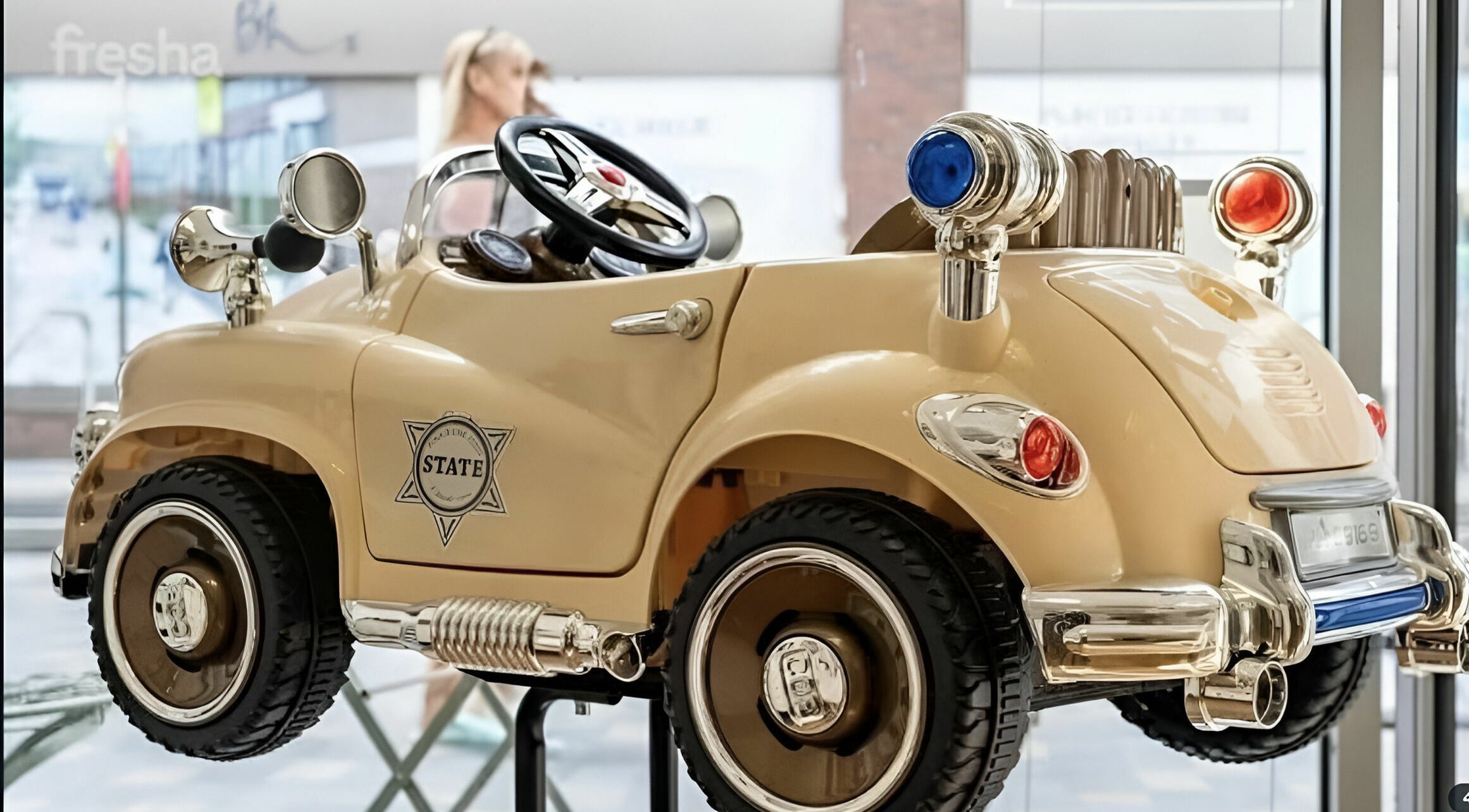 Elegant vintage-style toy car at Beauty by Fabi, Camberley, England, GB, enhancing playful decor.