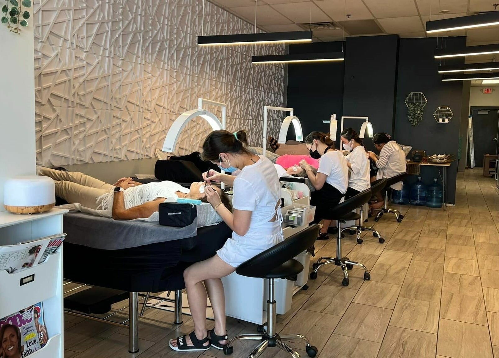 Clients enjoying treatments at XO Beauty Spa in Chatham, Illinois, US, showcasing a modern, relaxing environment.