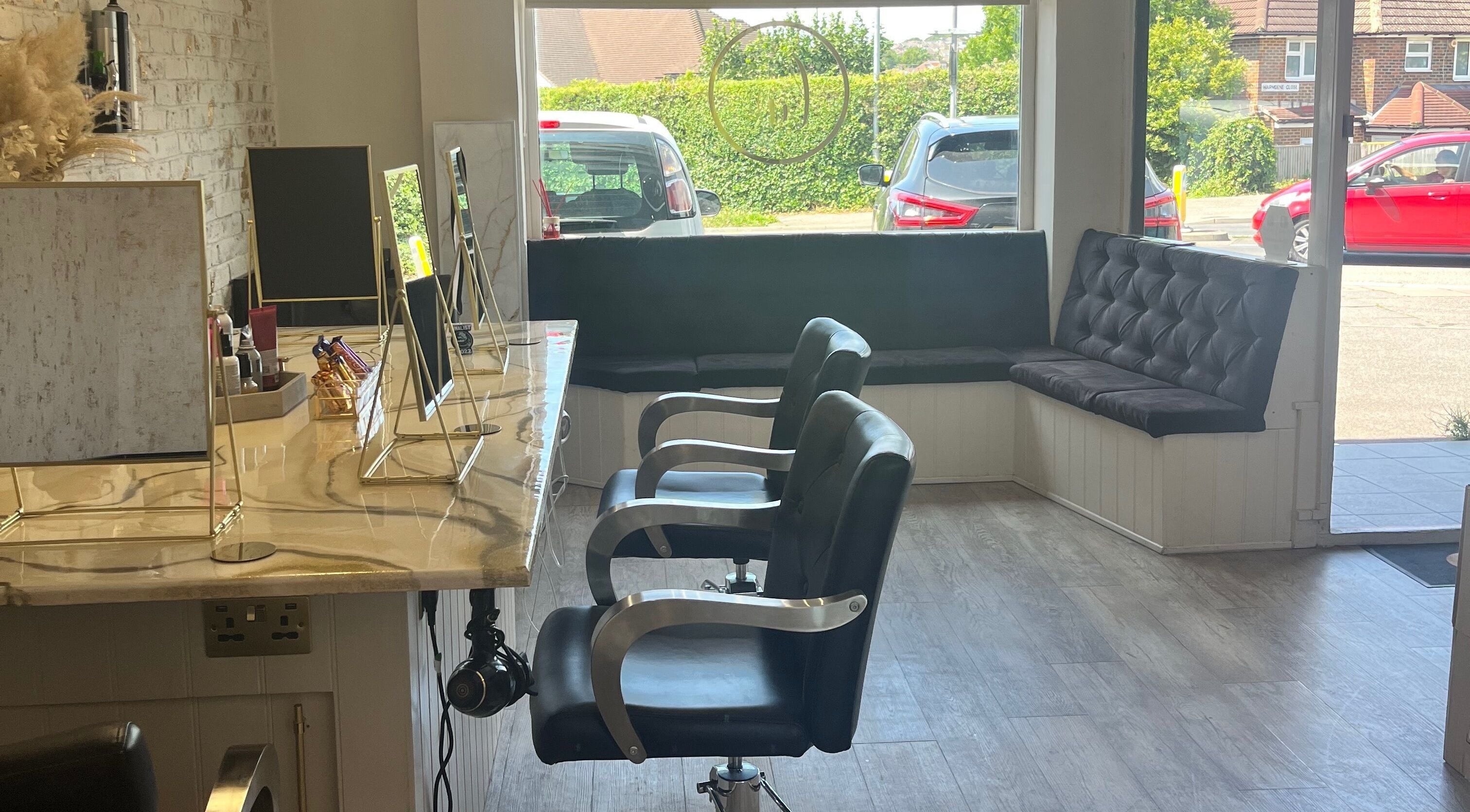 Modern salon interior at Lauren Walder Hair and Extensions, Brighton, England, GB, featuring stylish styling chairs.