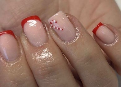 Festive red-tipped nails with candy cane design at Vanilla Salon, Leeds, England, GB.