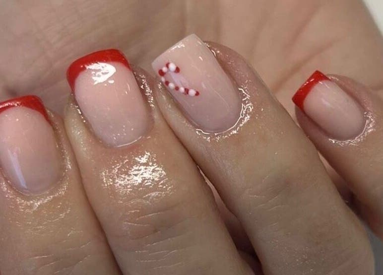 Festive red-tipped nails with candy cane design at Vanilla Salon, Leeds, England, GB.