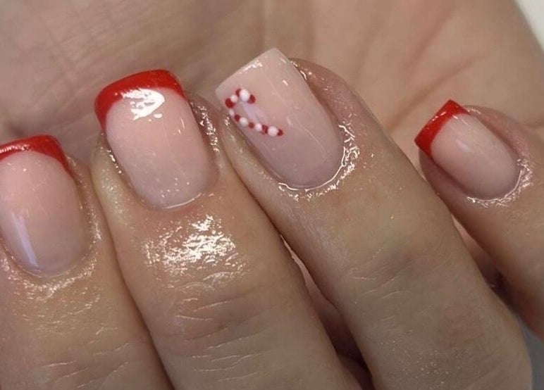 Festive red-tipped nails with candy cane design at Vanilla Salon, Leeds, England, GB.
