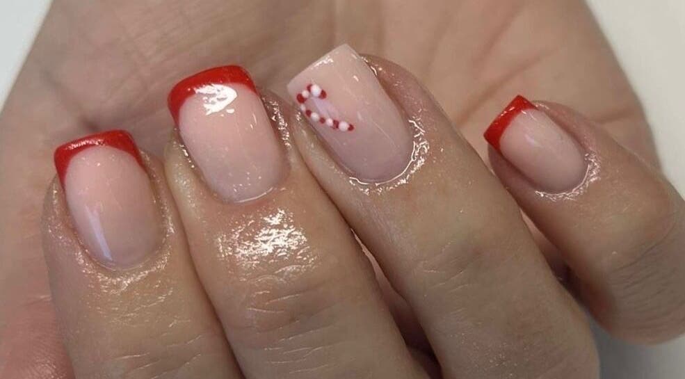 Festive red-tipped nails with candy cane design at Vanilla Salon, Leeds, England, GB.
