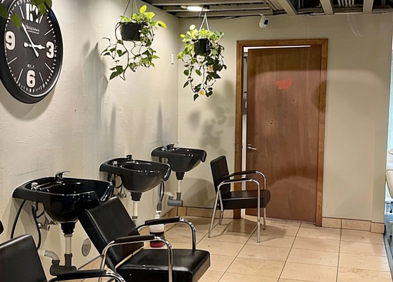 Modern salon lounge with wash stations at A Better U Beauty Barber Academy in Albuquerque, New Mexico, US.