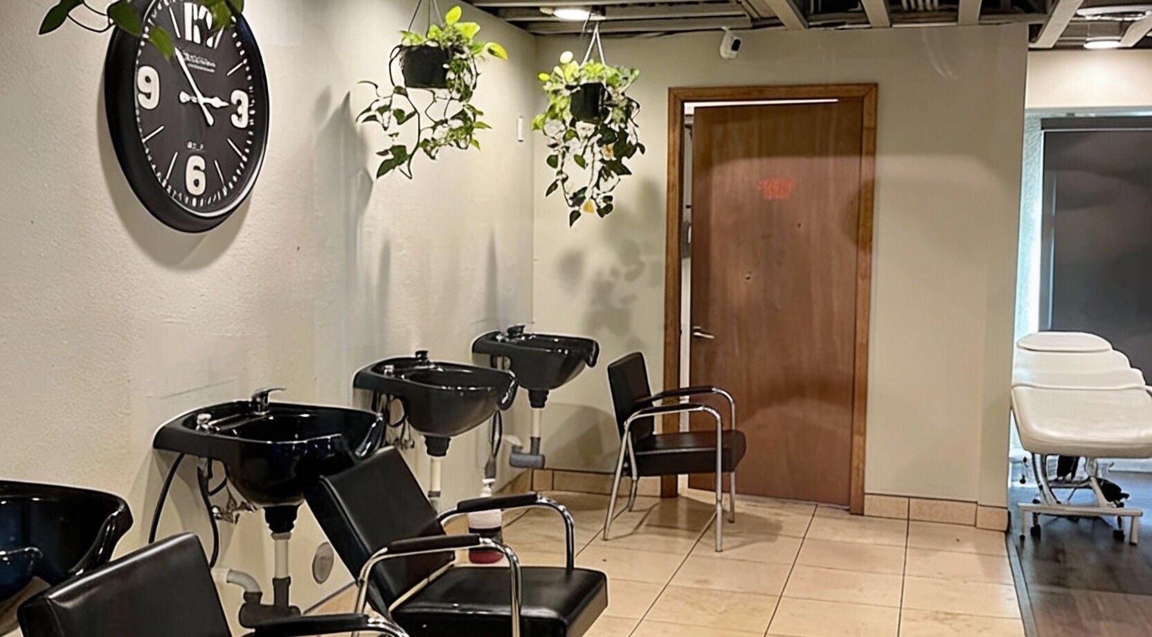 Modern salon lounge with wash stations at A Better U Beauty Barber Academy in Albuquerque, New Mexico, US.