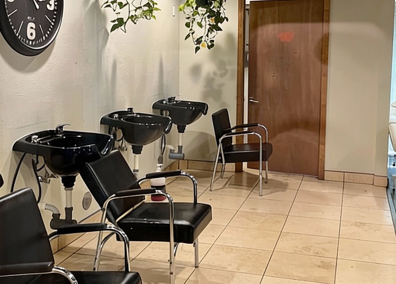 Modern salon interior at A Better U Beauty Barber Academy, Albuquerque, New Mexico. Stylish chairs and wash stations.