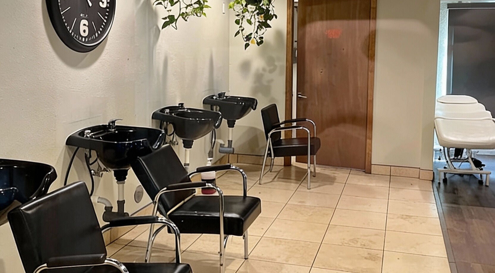 Modern salon interior at A Better U Beauty Barber Academy, Albuquerque, New Mexico. Stylish chairs and wash stations.