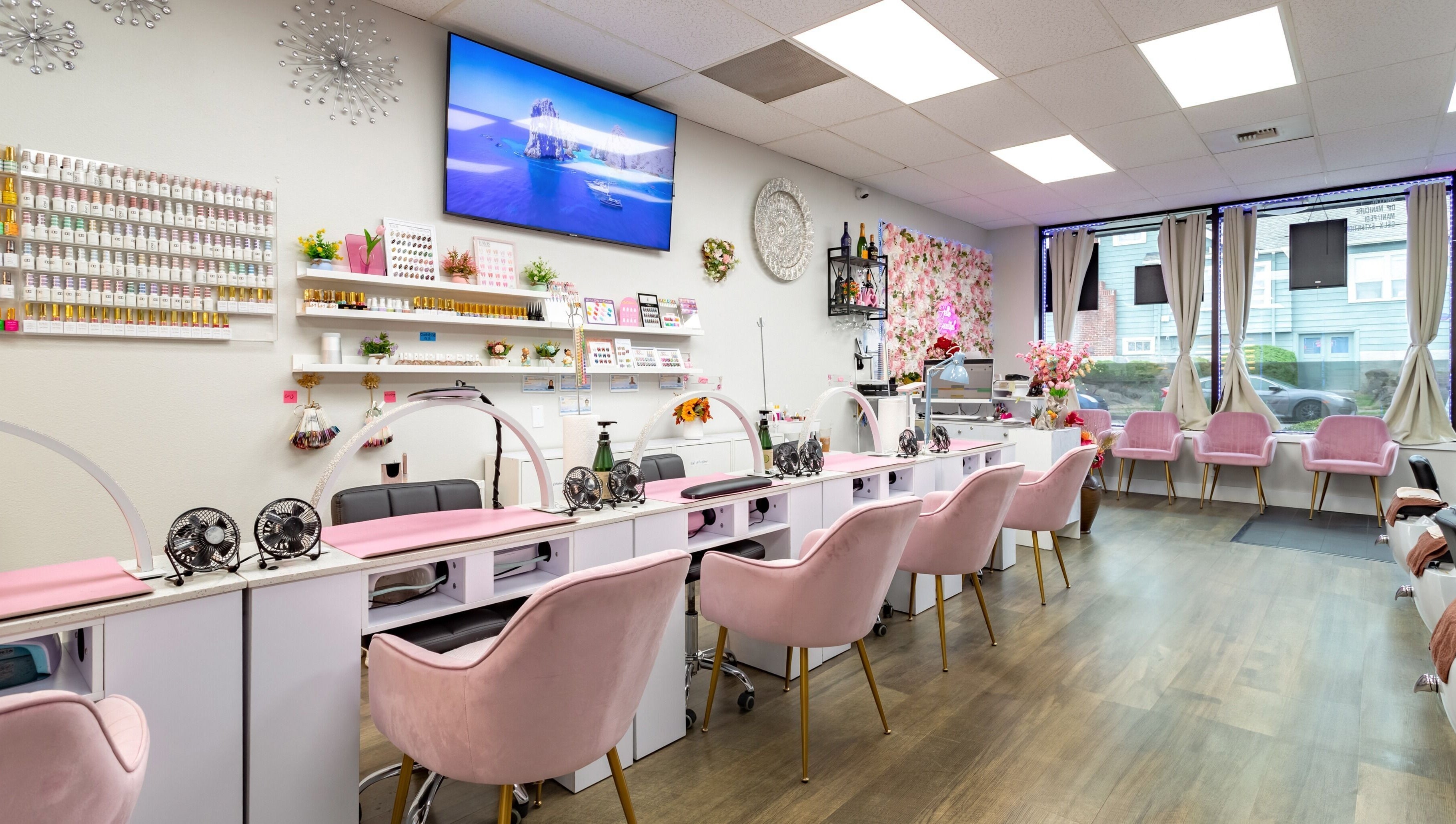 Jenny Nails Salon in Seattle, Washington, with chic pink chairs and elegant decor creating a serene ambiance.