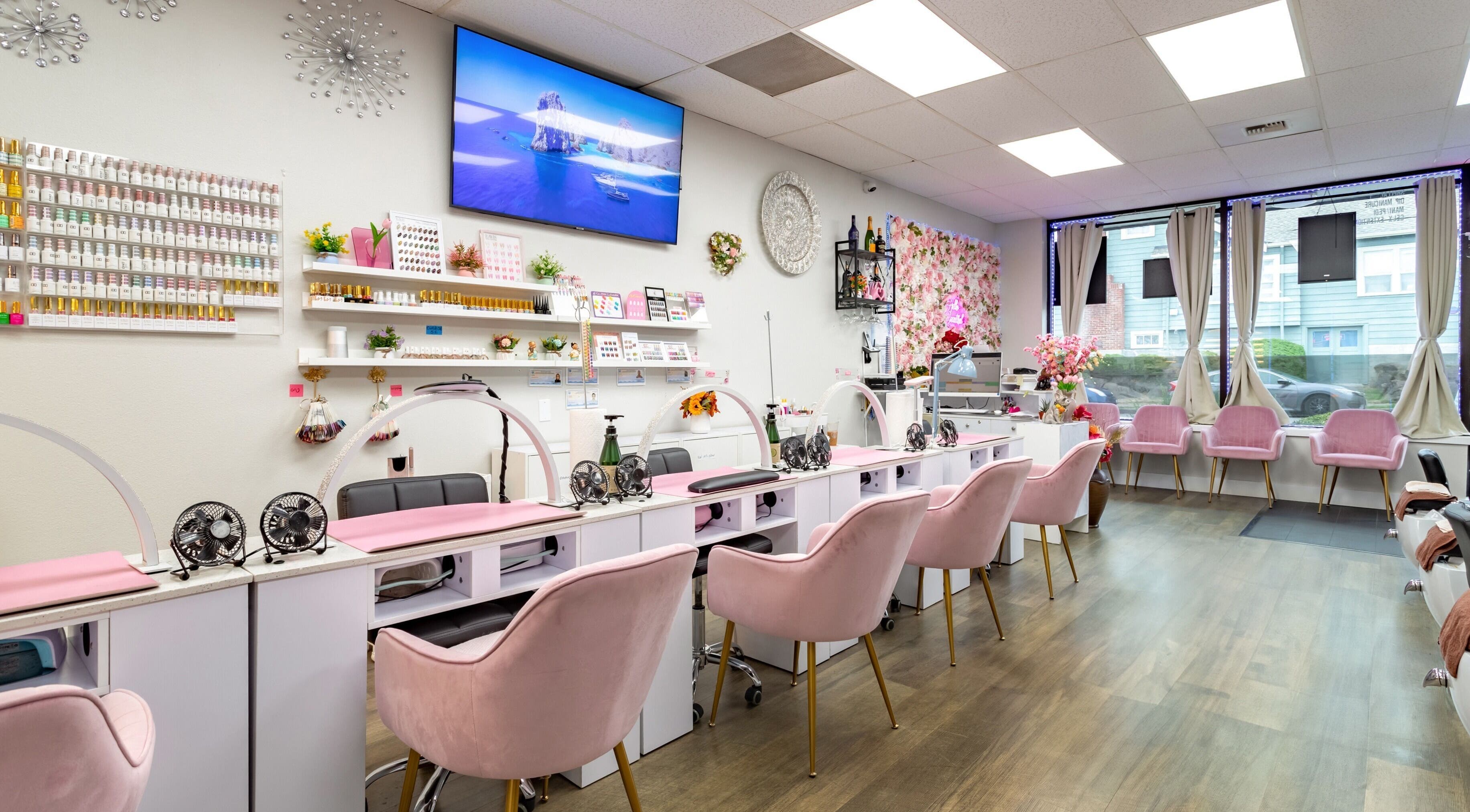 Jenny Nails Salon in Seattle, Washington, with chic pink chairs and elegant decor creating a serene ambiance.
