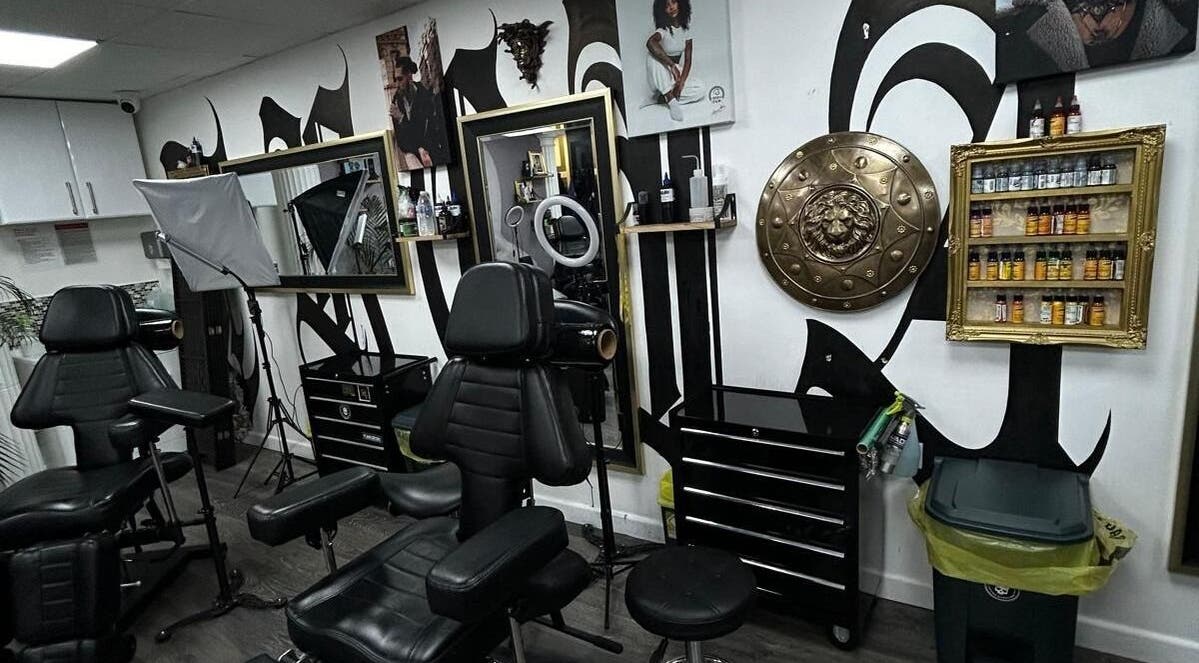 Interior of Trojan Ink in London, England, GB showcasing a tattoo station with vibrant decor and supplies.