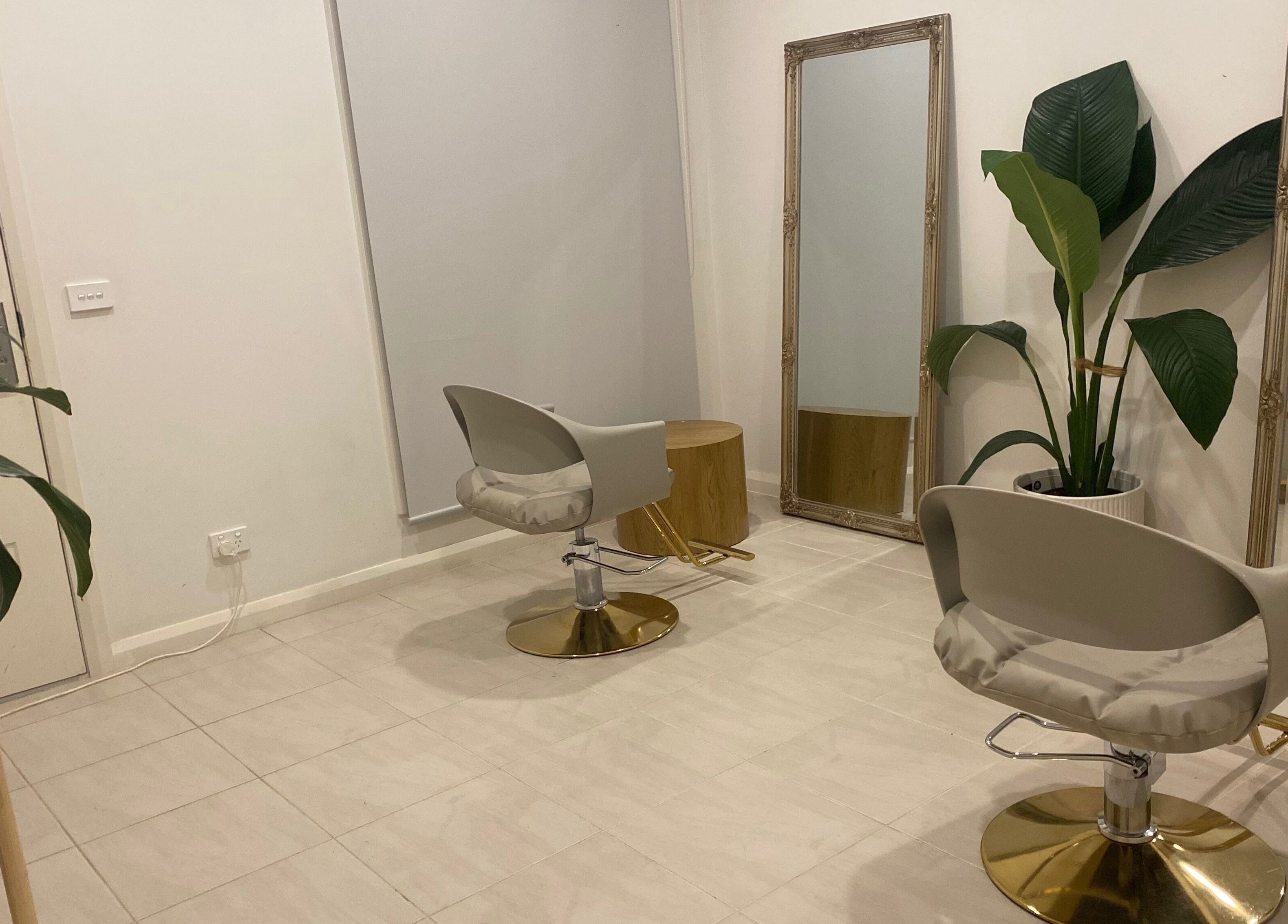 Elegant interior of MISSD and Co Salon in Melbourne, Victoria, AU featuring modern chairs and lush greenery.