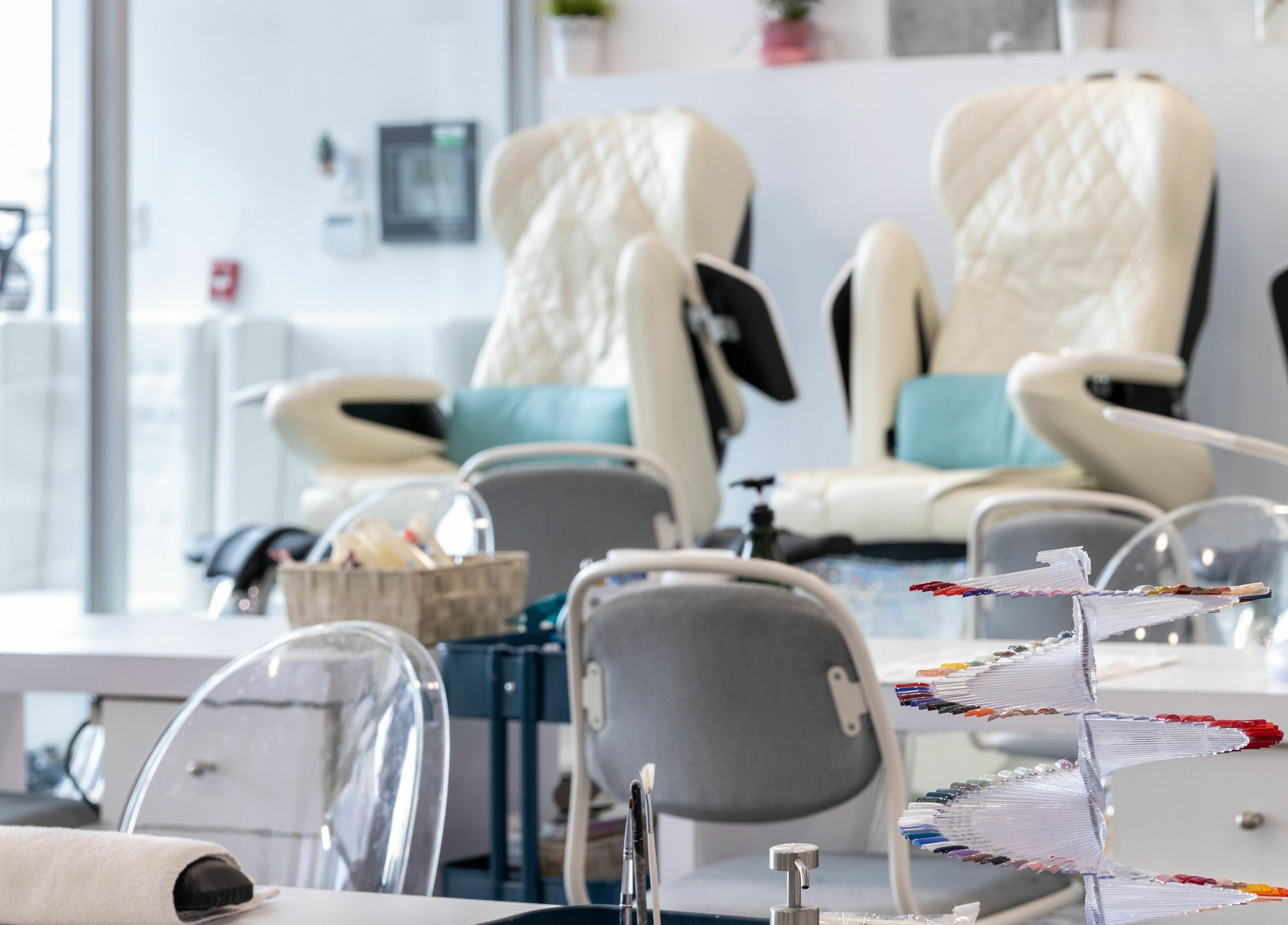 Tmr Nails Bar interior with plush chairs and a polish display in Mont-Royal, Québec, CA.