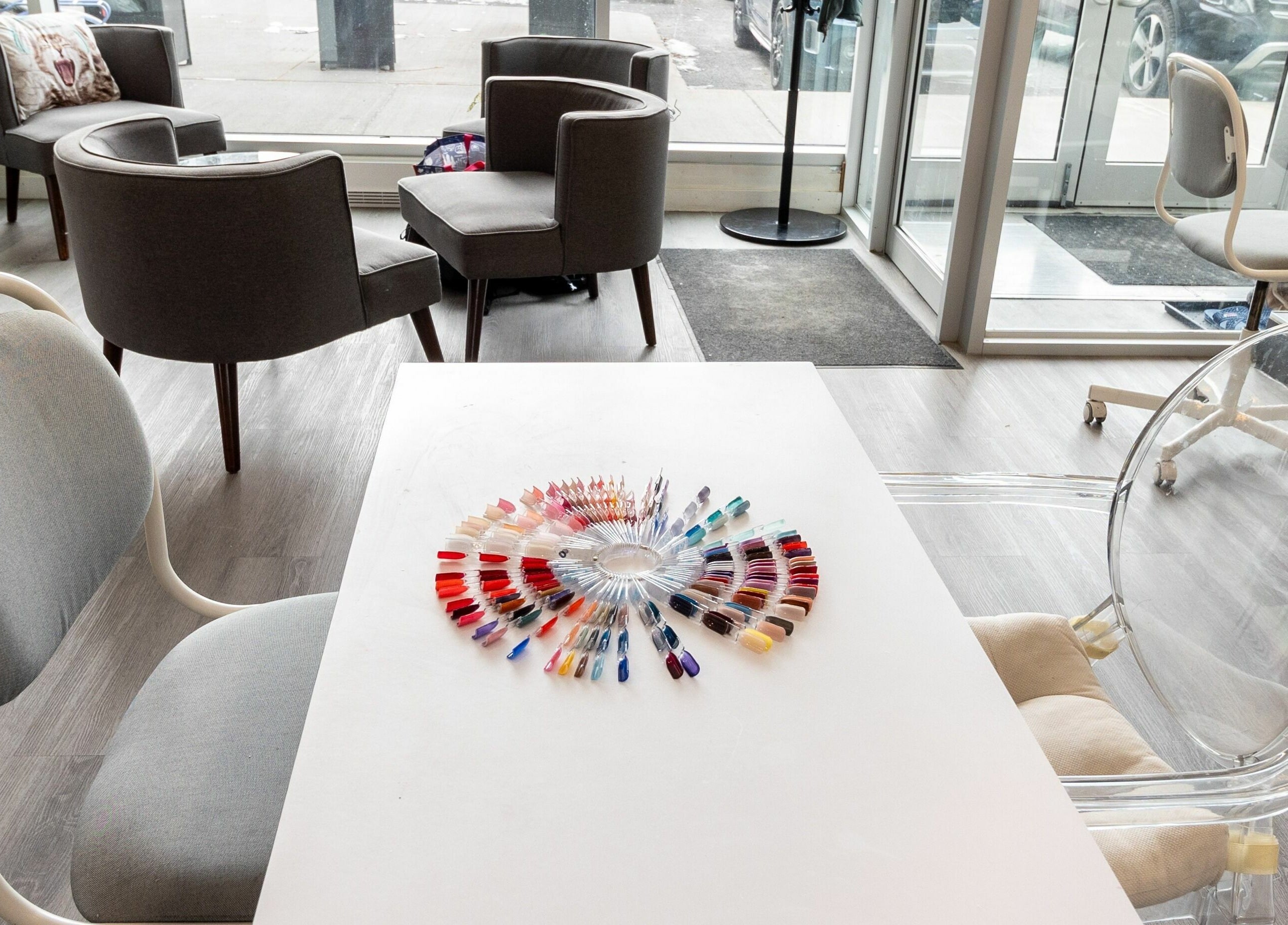 Elegant nail color palette at Tmr Nails Bar, Mont-Royal, Québec, CA, showcasing vibrant hues in a chic setting.