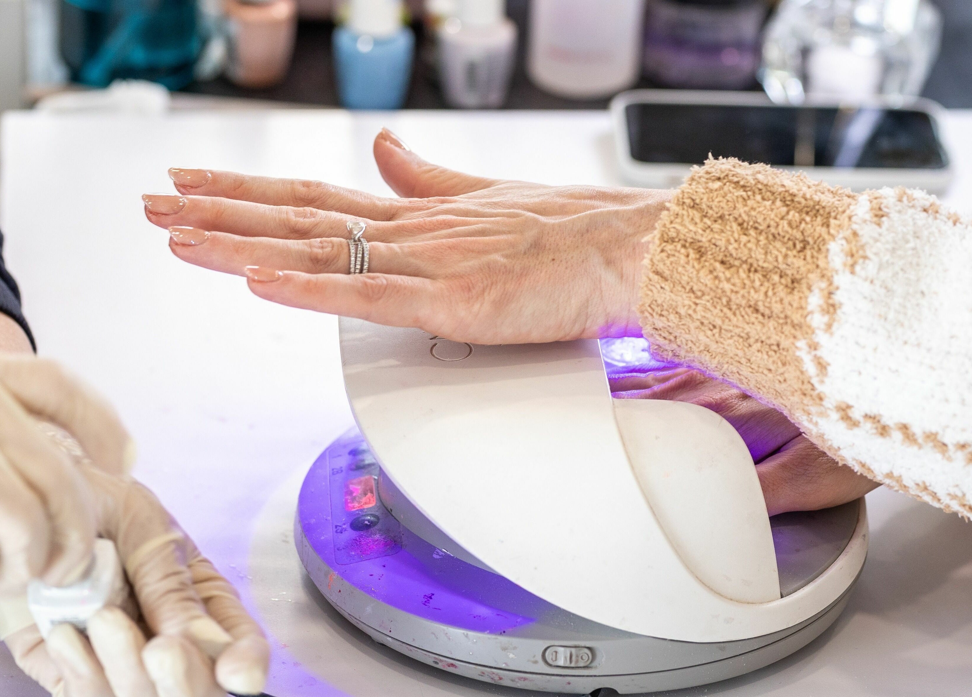 Gel manicure under UV light at Tmr Nails Bar, Mont-Royal, Québec, CA. Chic nail service with care.