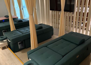 Massage area at LUX Head and Body Spa, Riverstone, New South Wales, with plush adjustable beds and curtains.
