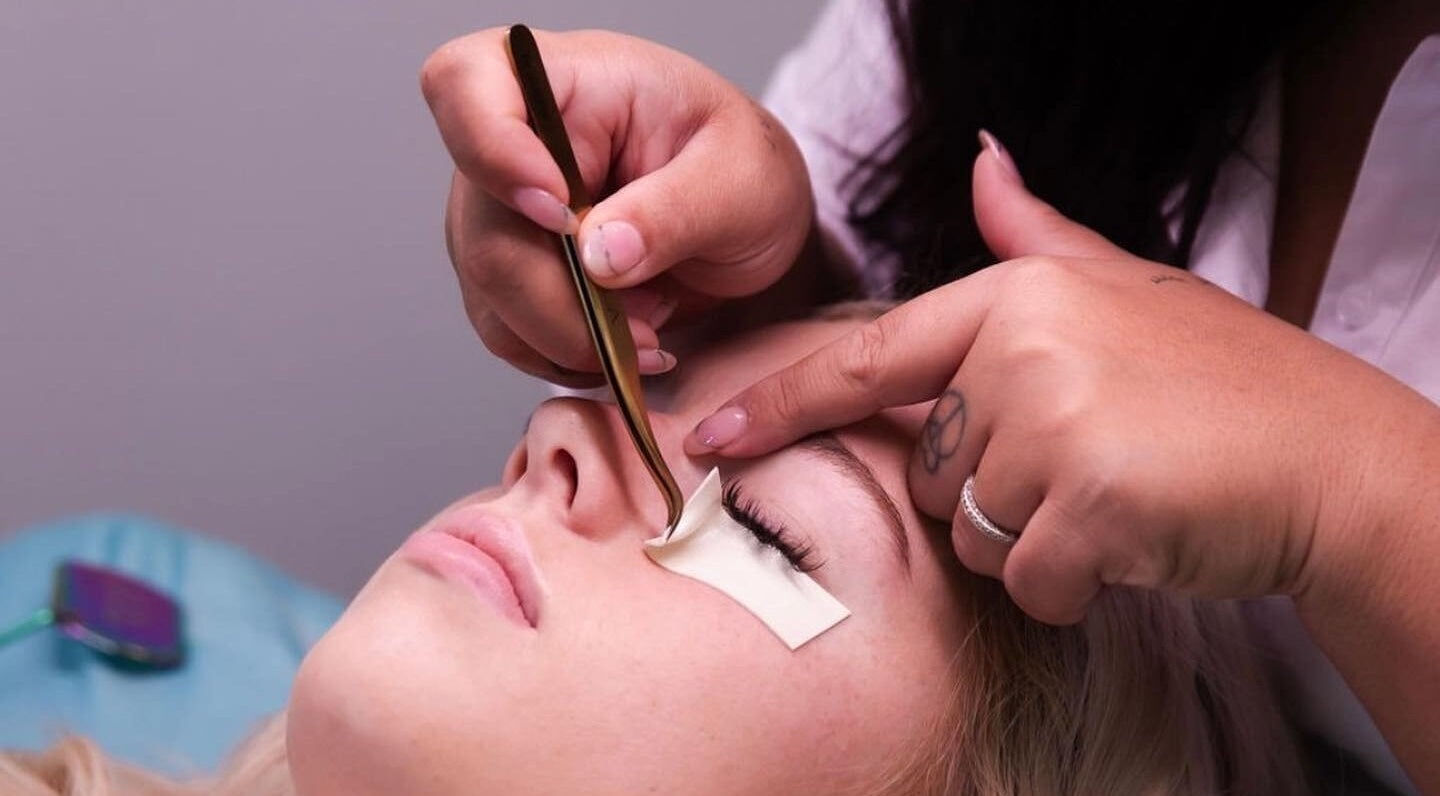 Expert applying eyelash extensions at LASHHOOD SOCIETY in Petrie, Queensland, AU.