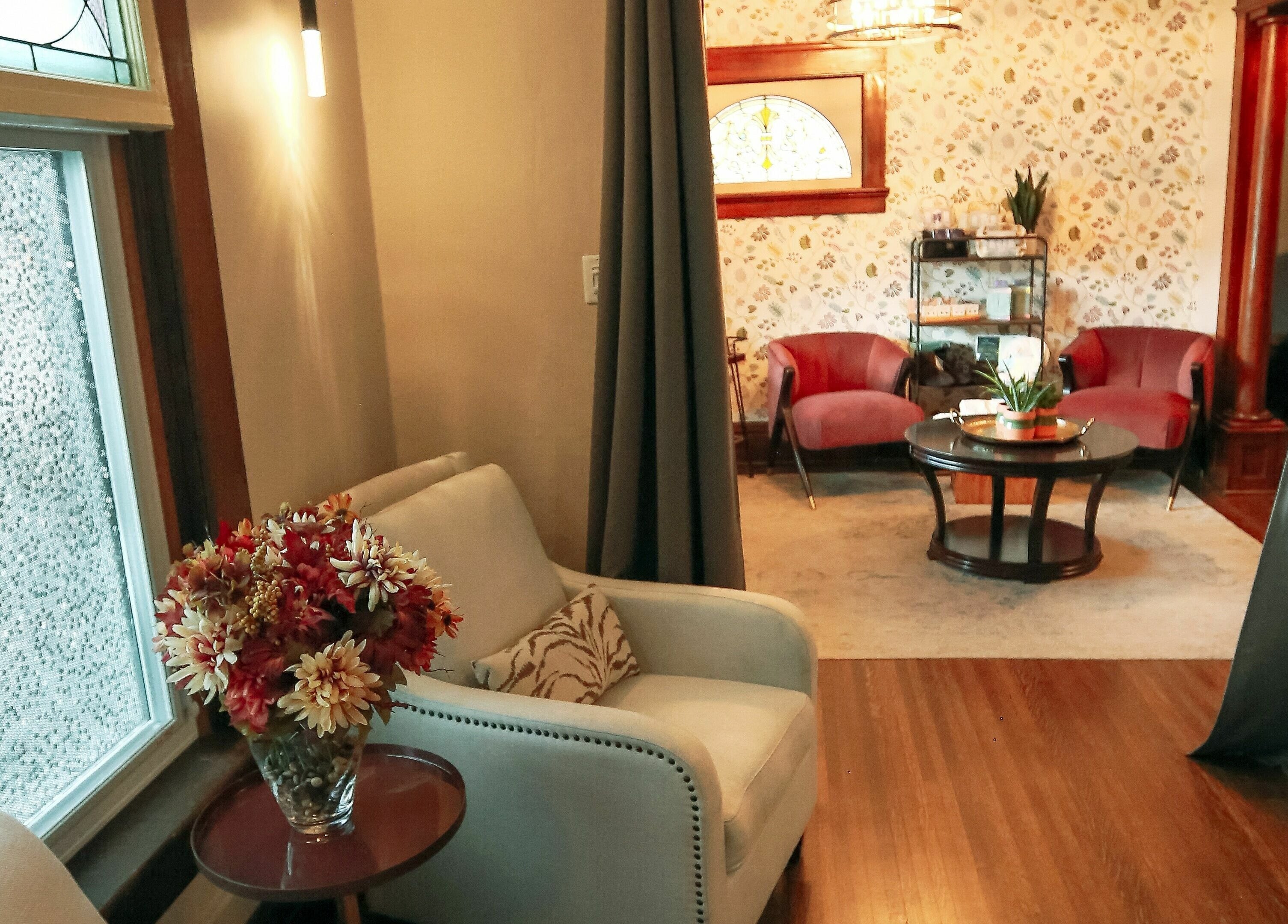 Elegant seating area at Relish Day Spa, Stratford, Ontario, CA showcasing plush chairs and floral decor.