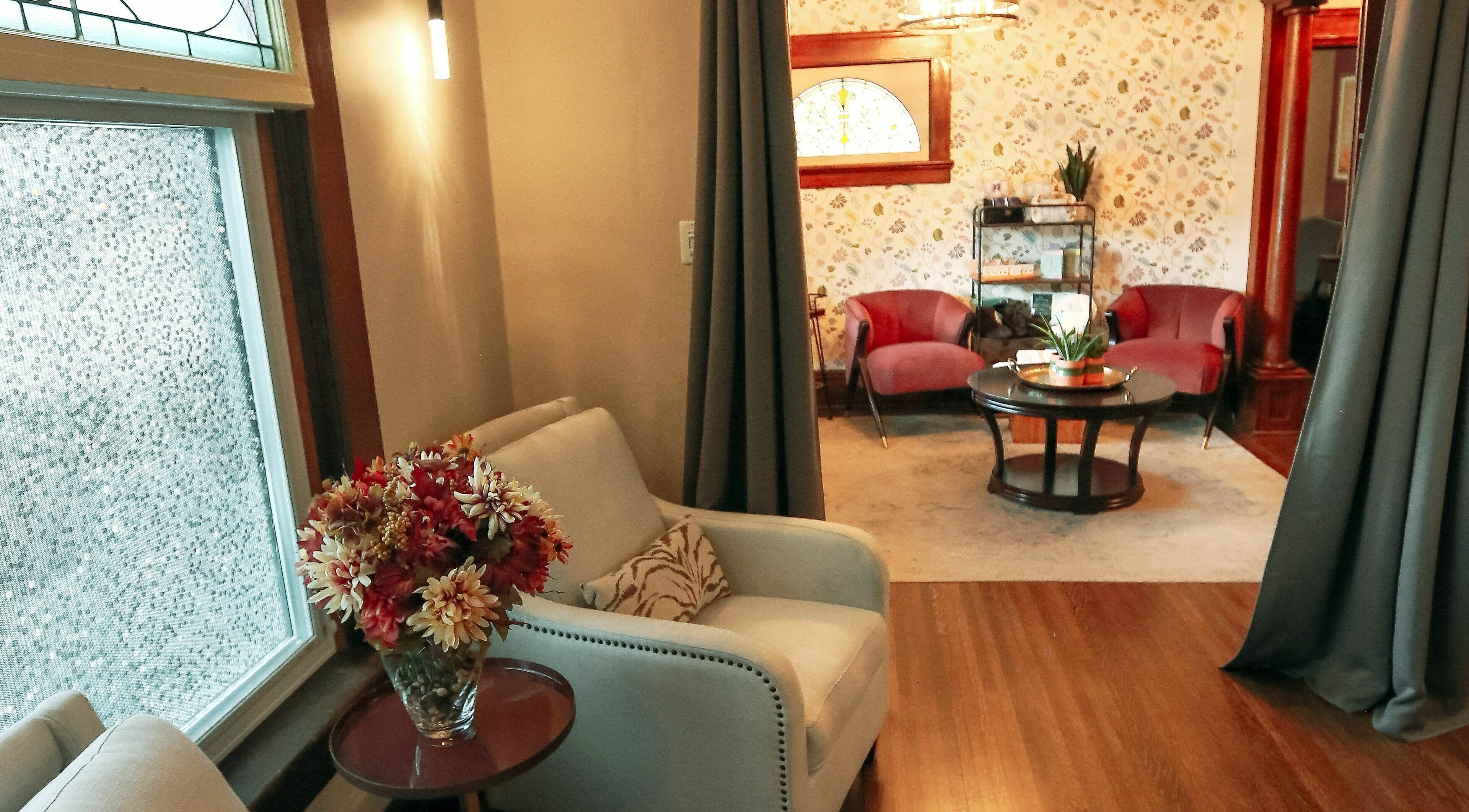 Elegant seating area at Relish Day Spa, Stratford, Ontario, CA showcasing plush chairs and floral decor.