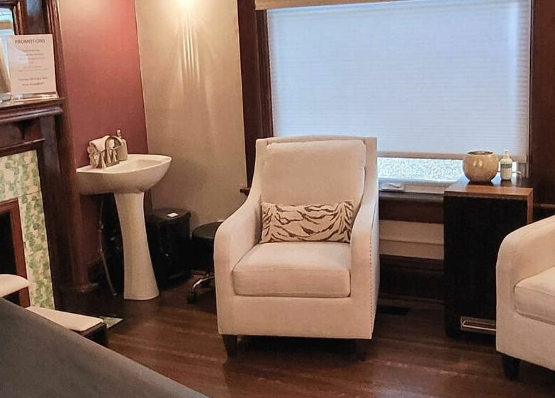 Elegant relaxation area at Relish Day Spa in Stratford, Ontario, CA featuring plush white chairs and soothing decor.