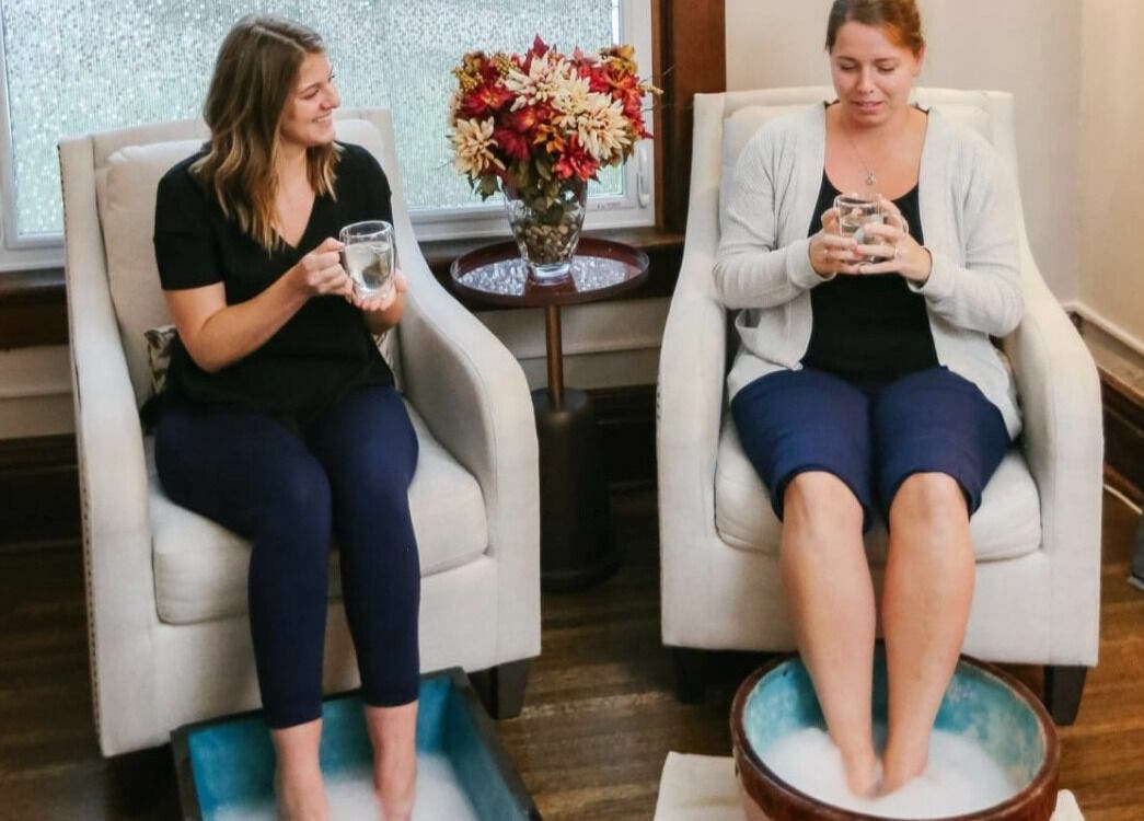 Relaxing foot soak experience at Relish Day Spa, Stratford, Ontario, CA with two women enjoying drinks.