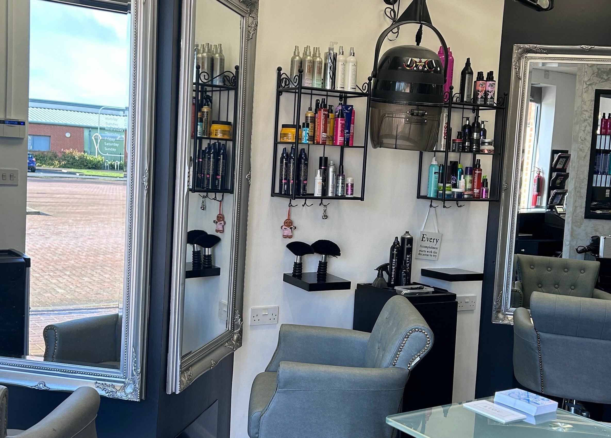Interior of Ice Hair and Barbers in Quedgeley, England, GB, featuring elegant mirrors and styling chairs.