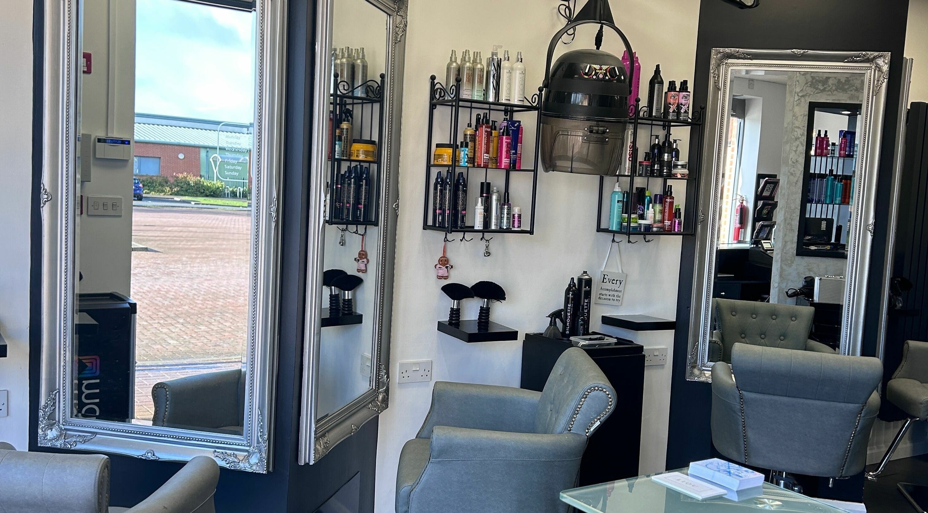Interior of Ice Hair and Barbers in Quedgeley, England, GB, featuring elegant mirrors and styling chairs.