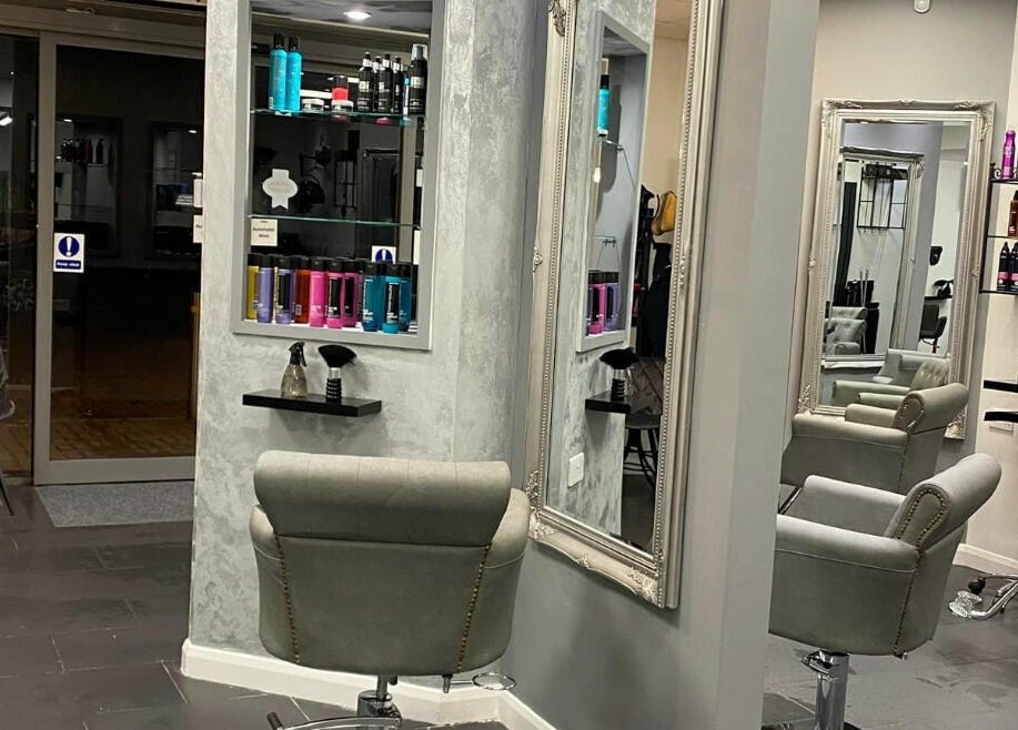 Elegant interior of Ice Hair and Barbers in Quedgeley, England, GB showcasing sleek styling chairs and modern decor.