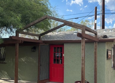 Exterior view of The Right Touch Massage LLC in Tucson, Arizona, US with a welcoming red door entrance.
