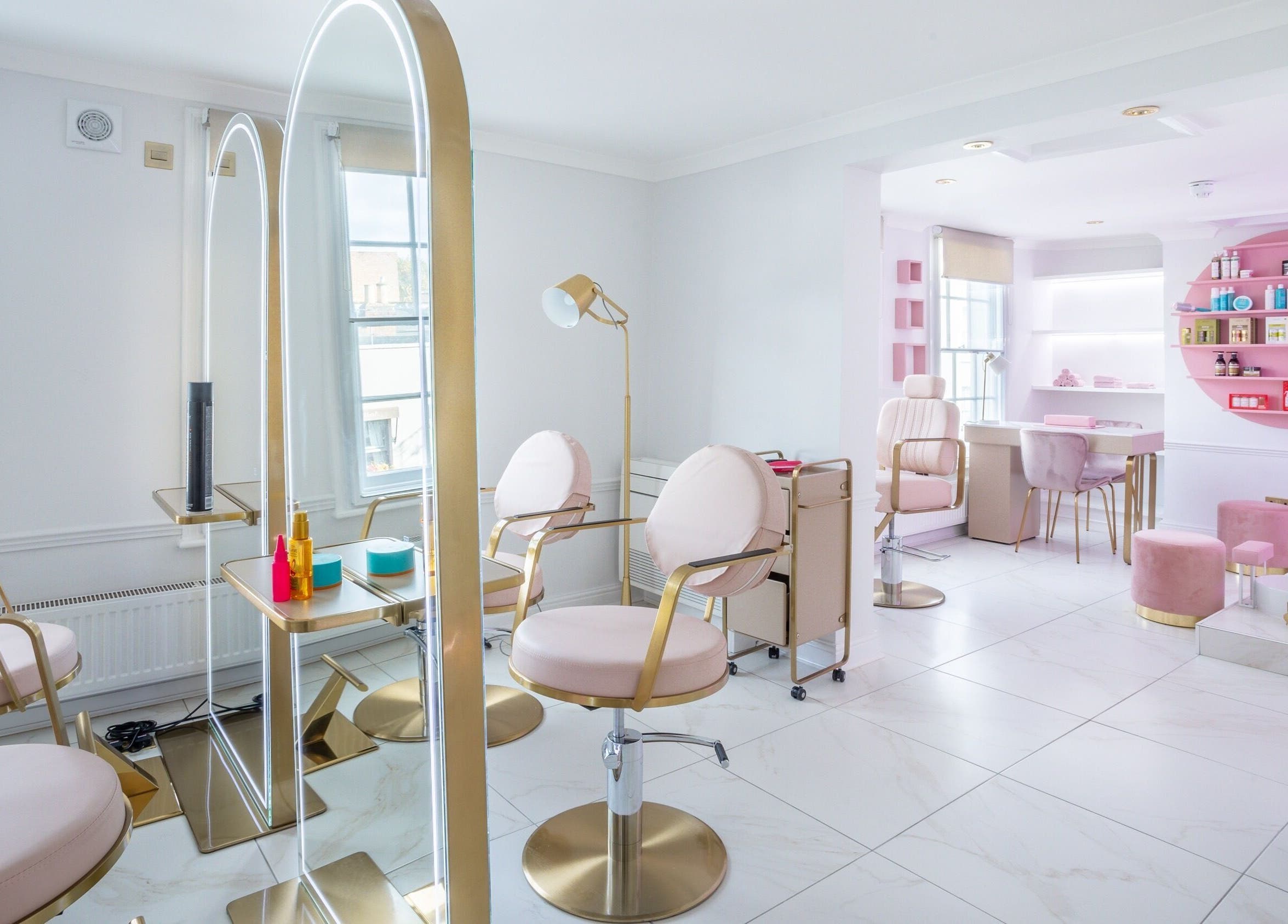 Elegant interior of The Dolls London SW3, London, England, GB. Modern beauty salon with stylish seating and decor.