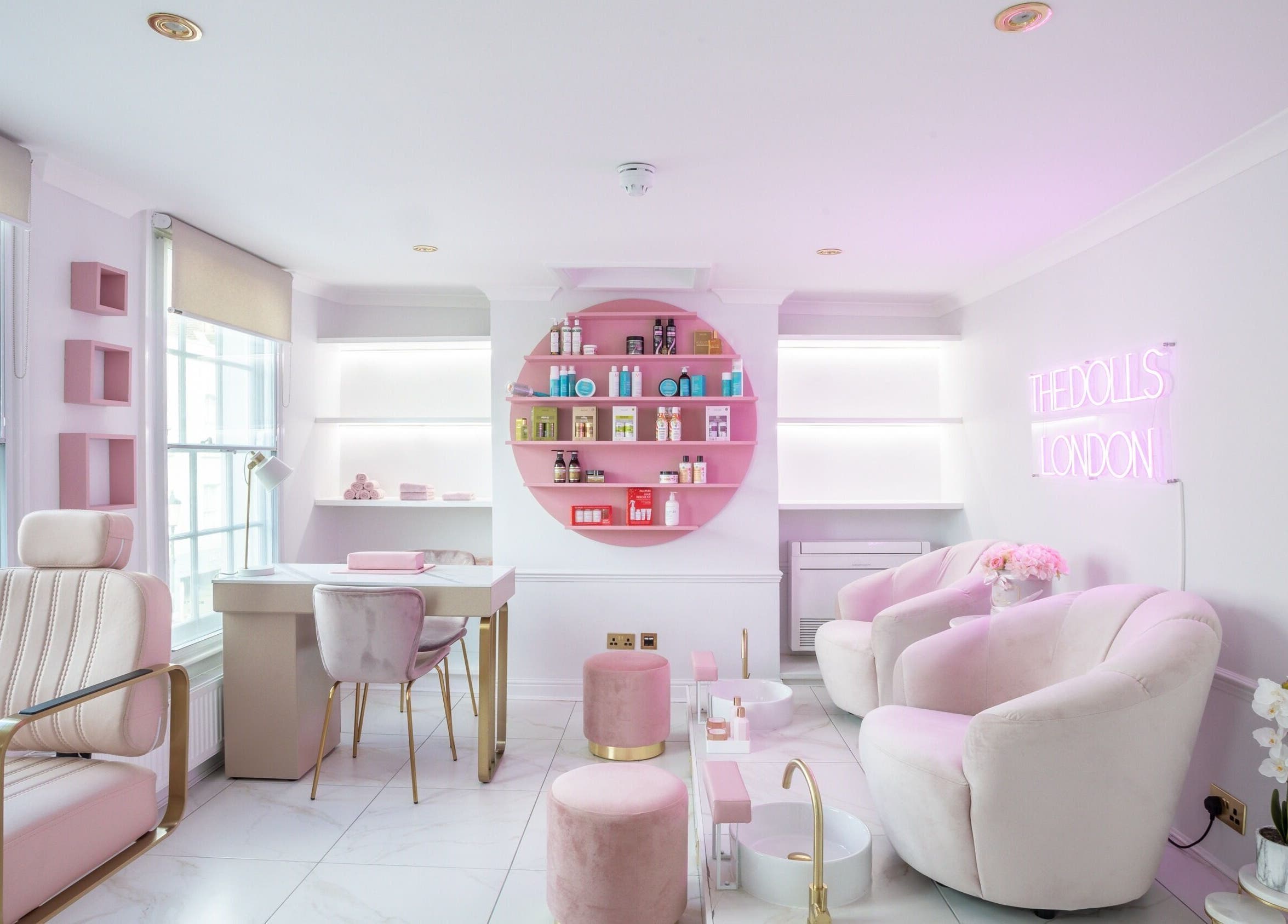 Elegant and modern interior of The Dolls London SW3 beauty lounge in London, England, GB with pink accents.