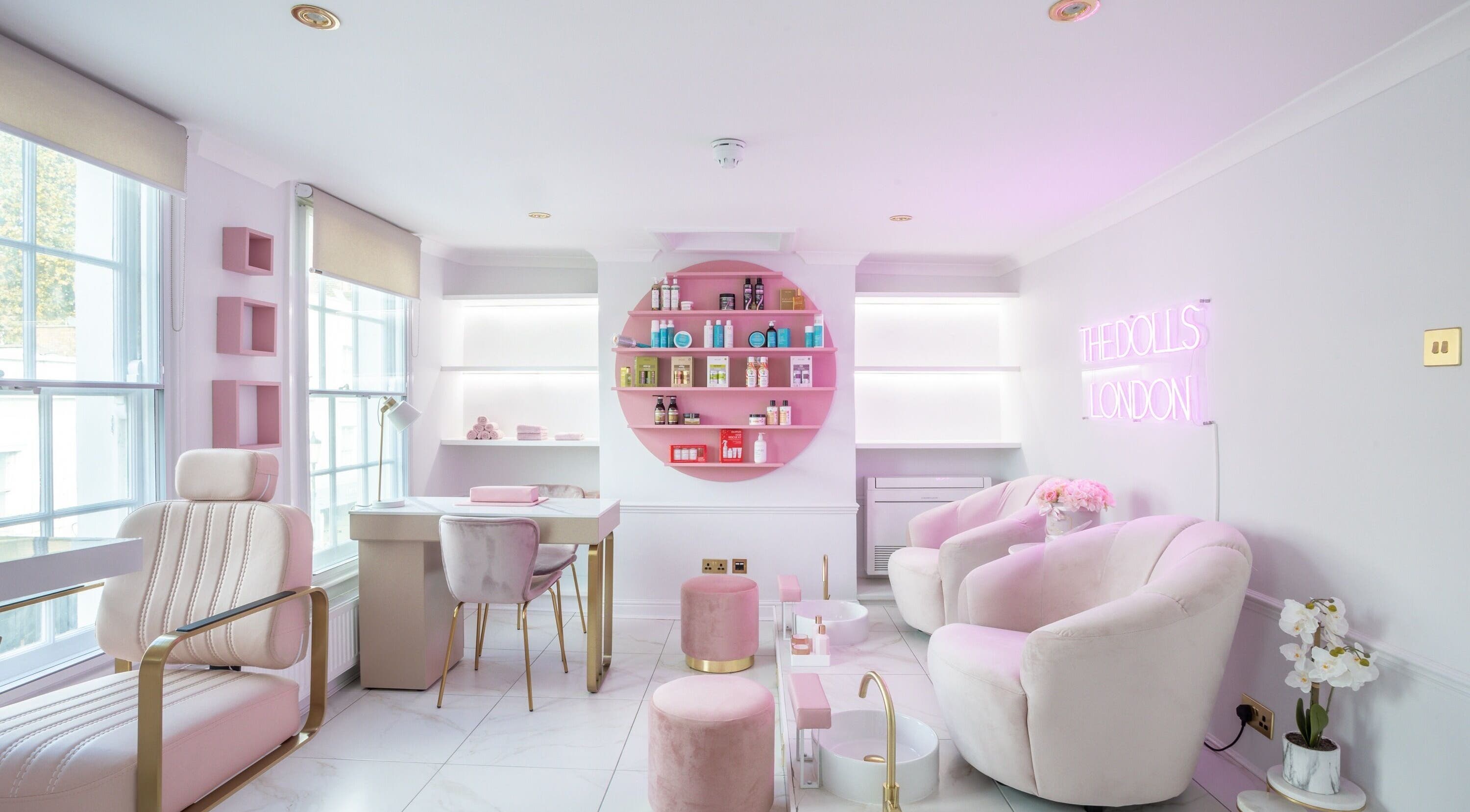 Elegant and modern interior of The Dolls London SW3 beauty lounge in London, England, GB with pink accents.