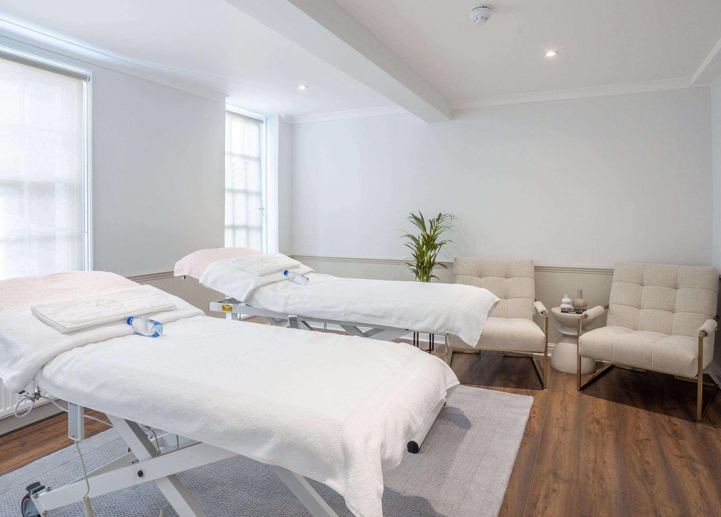Relaxing treatment room at The Dolls London SW3 with comfy chairs and massage tables, London, England, GB.