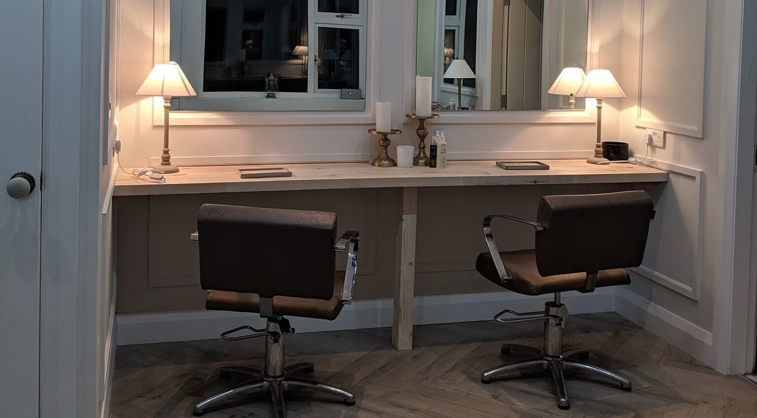 Elegant styling area at Mary Kearns Hair, Rathdowney, County Laois, IE, featuring cozy lighting and modern chairs.