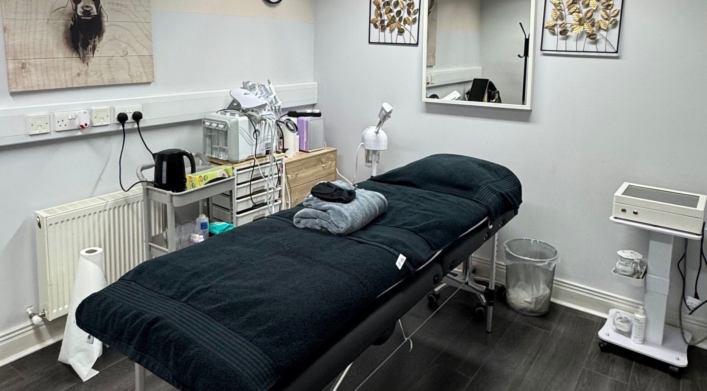 Bella Beauty Bar treatment room with black massage table in Cork, County Cork, IE.