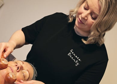 Aesthetician at Senses Beauty in Warwick, England, GB performing a calming facial massage.
