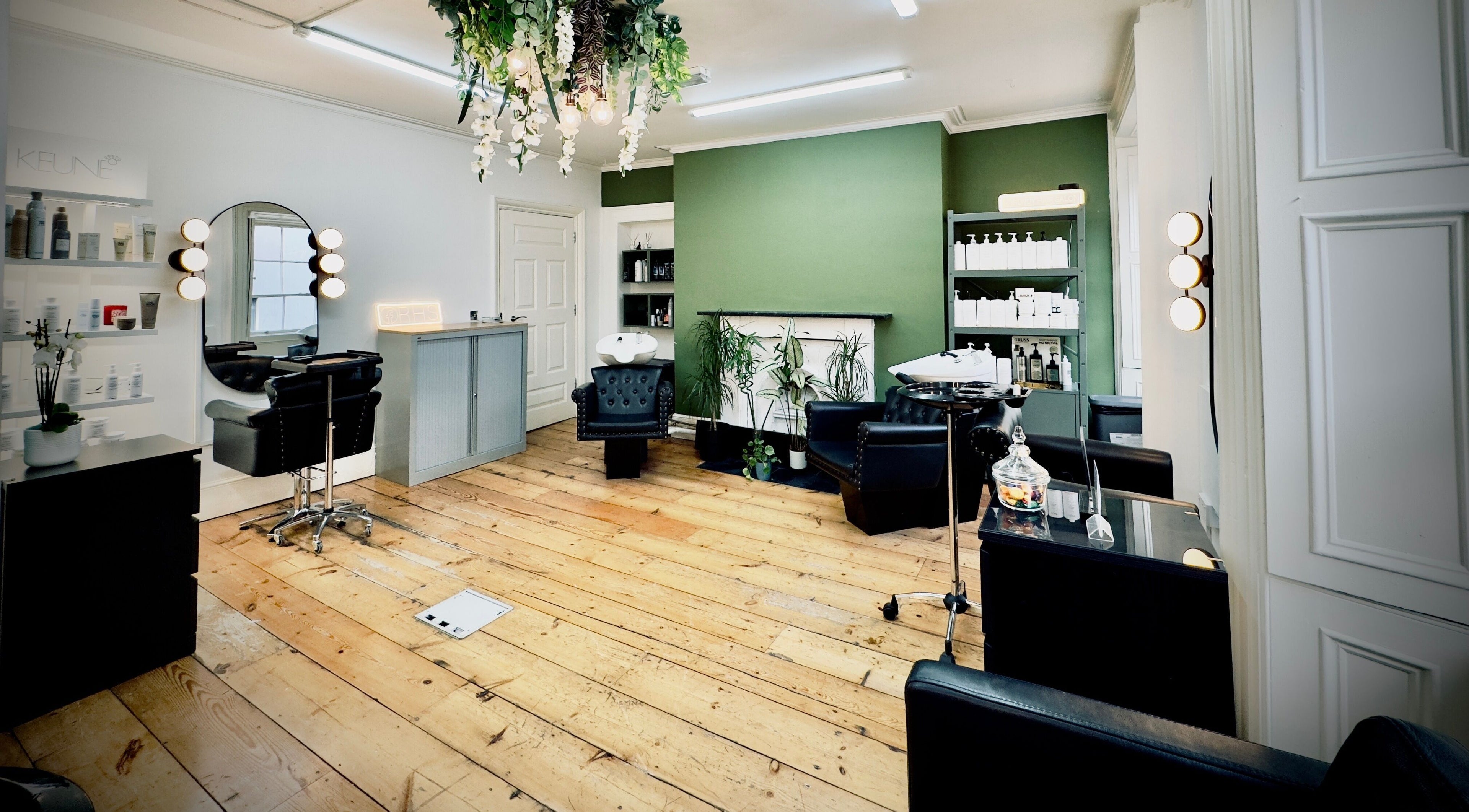 Relaxing interior of Rendy Hair Salon, Dublin, County Dublin, IE with modern decor and lush greenery.