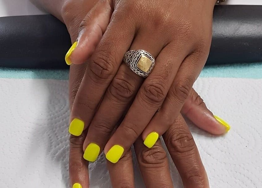 Neon yellow manicure at iCandy, Rodney Bay, Gros Islet, LC, showcasing polished hands with elegance.