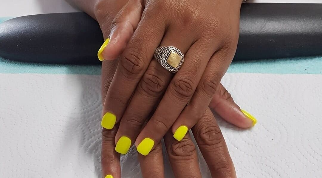Neon yellow manicure at iCandy, Rodney Bay, Gros Islet, LC, showcasing polished hands with elegance.