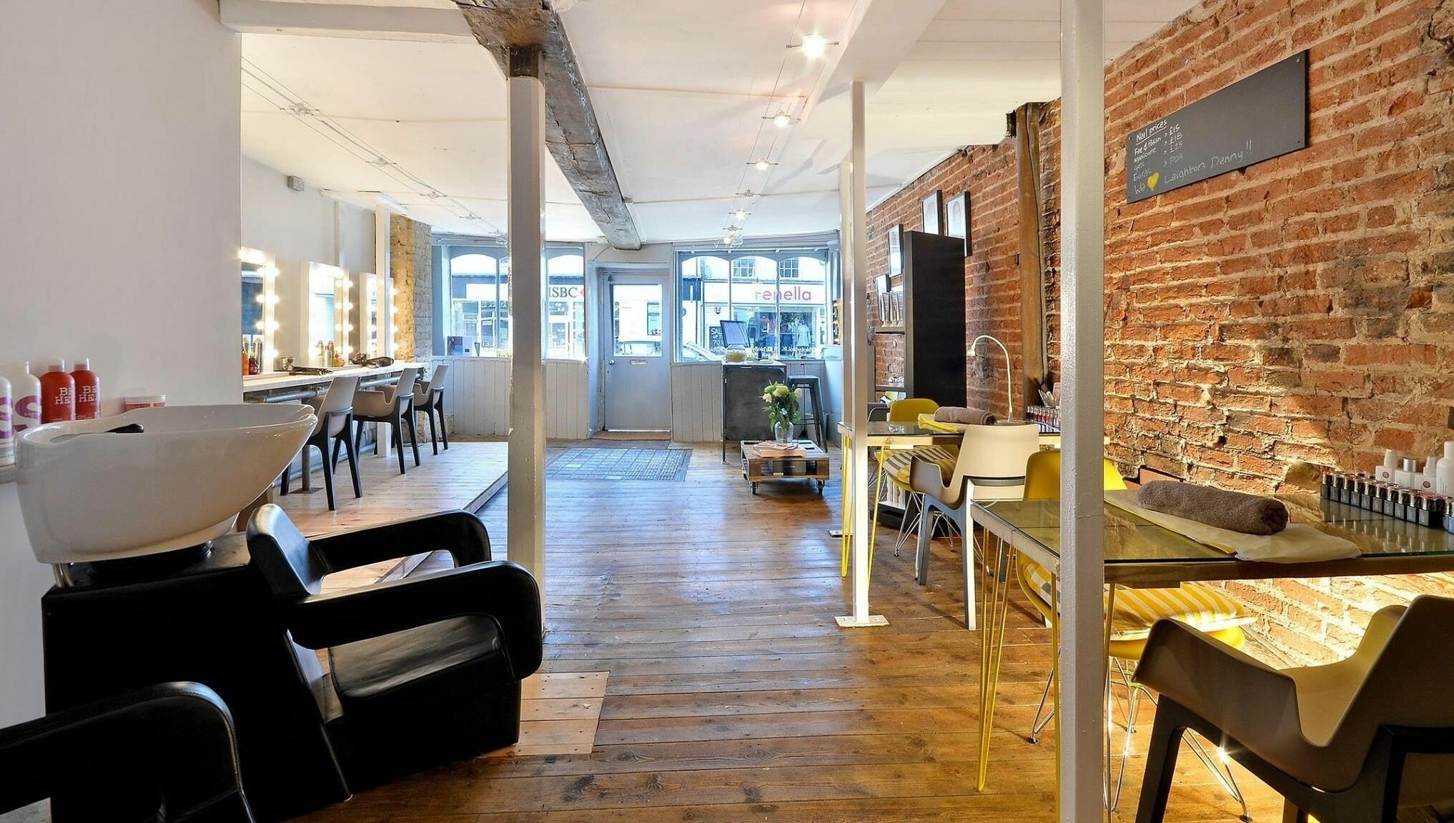 Chic interior of Blo by Blo in Ware, England, GB, featuring wooden floors and stylish salon stations.