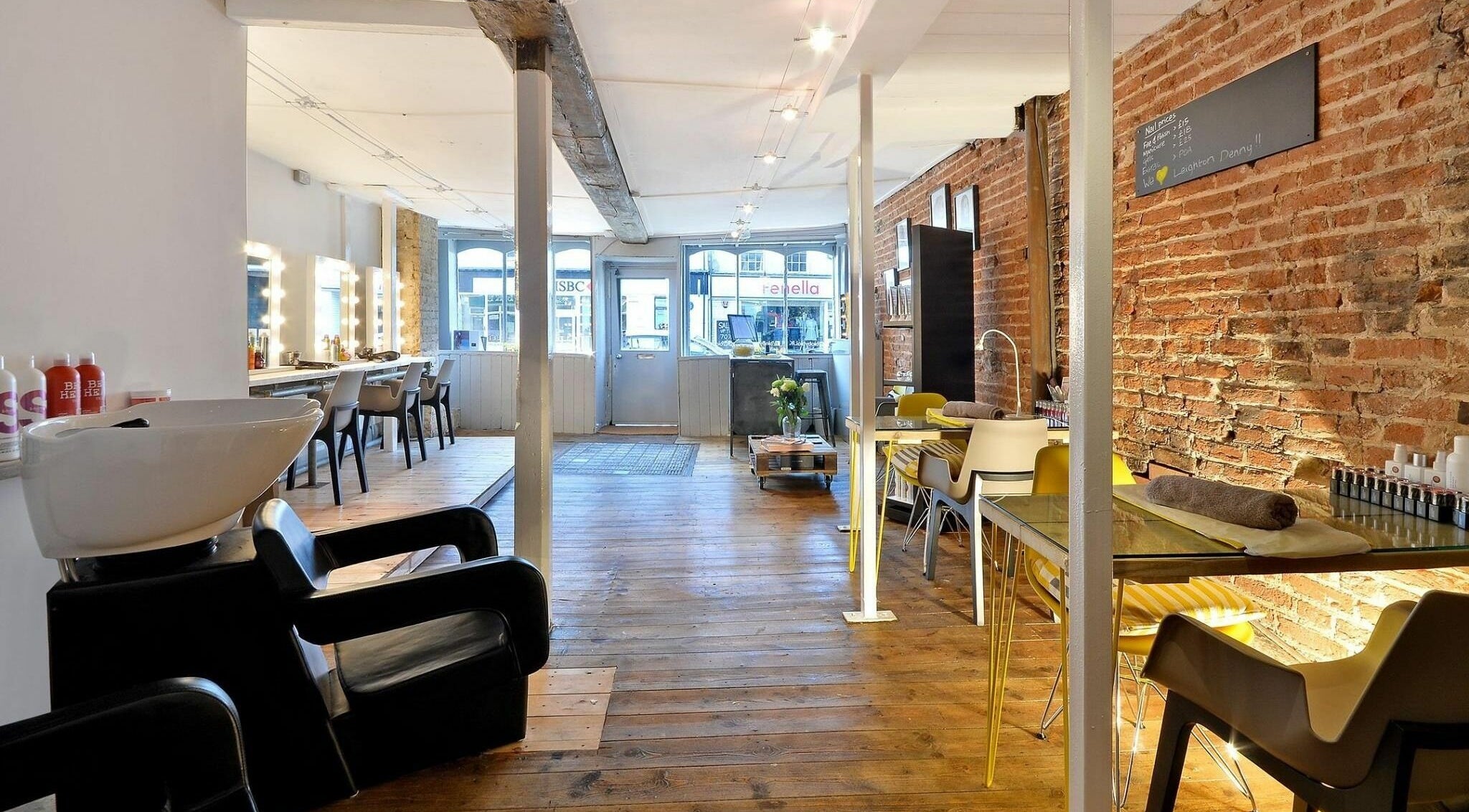 Chic interior of Blo by Blo in Ware, England, GB, featuring wooden floors and stylish salon stations.