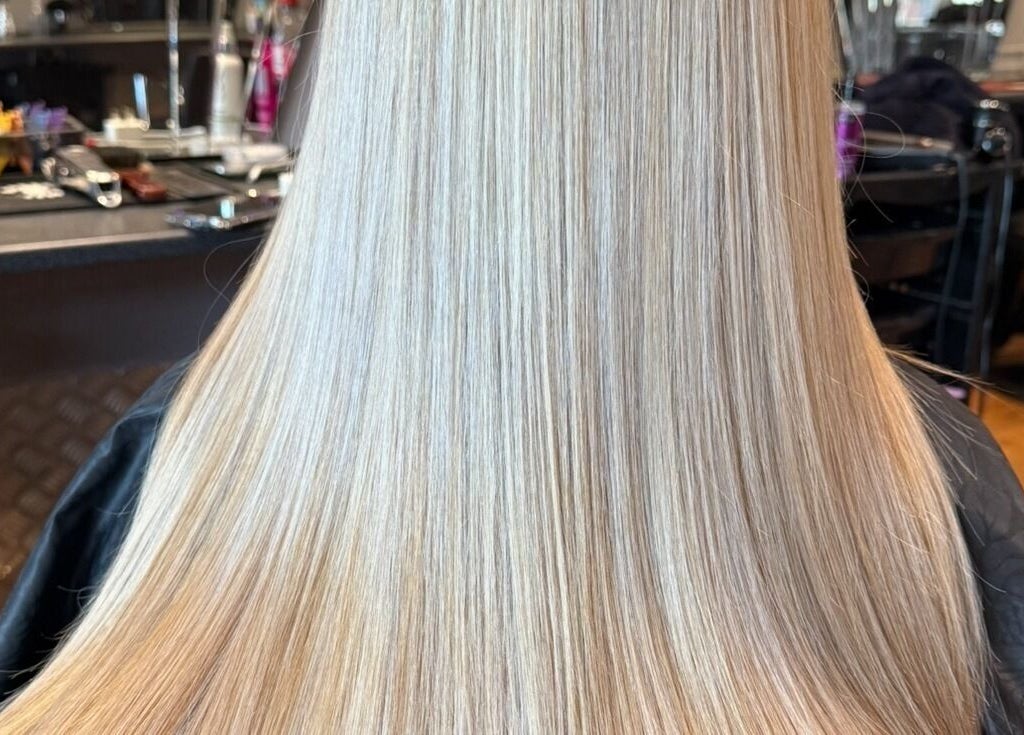 Sleek, straightened blonde hair at Colour Queen, Scunthorpe, England, GB, exhibiting professional styling.