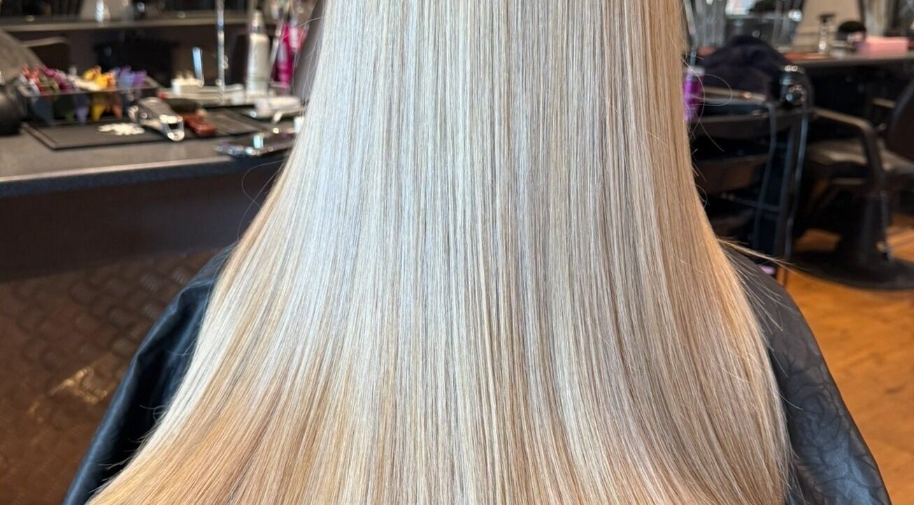 Sleek, straightened blonde hair at Colour Queen, Scunthorpe, England, GB, exhibiting professional styling.