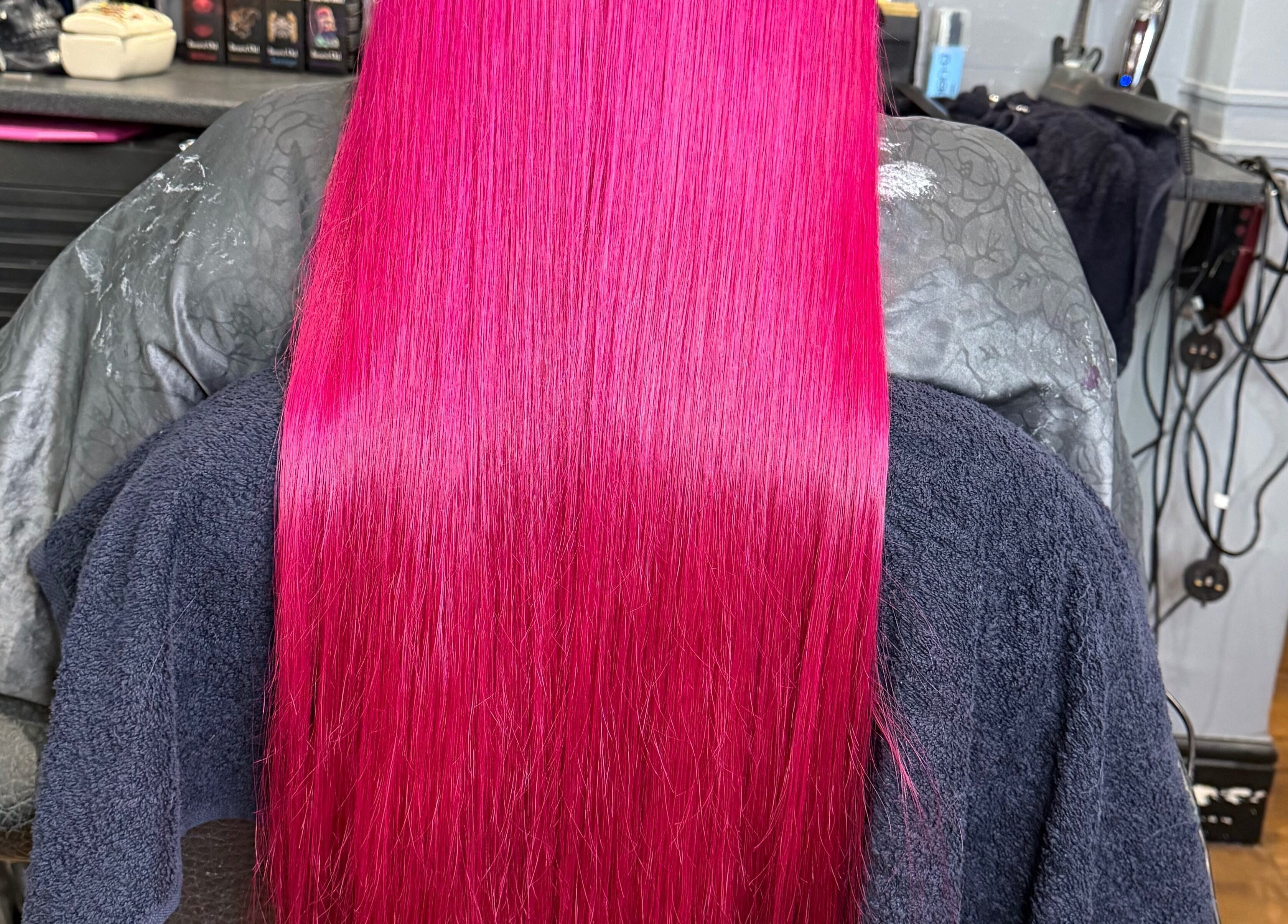 Bright magenta hair styled at Colour Queen, Scunthorpe, England, GB, showcasing salon's vibrant color expertise.