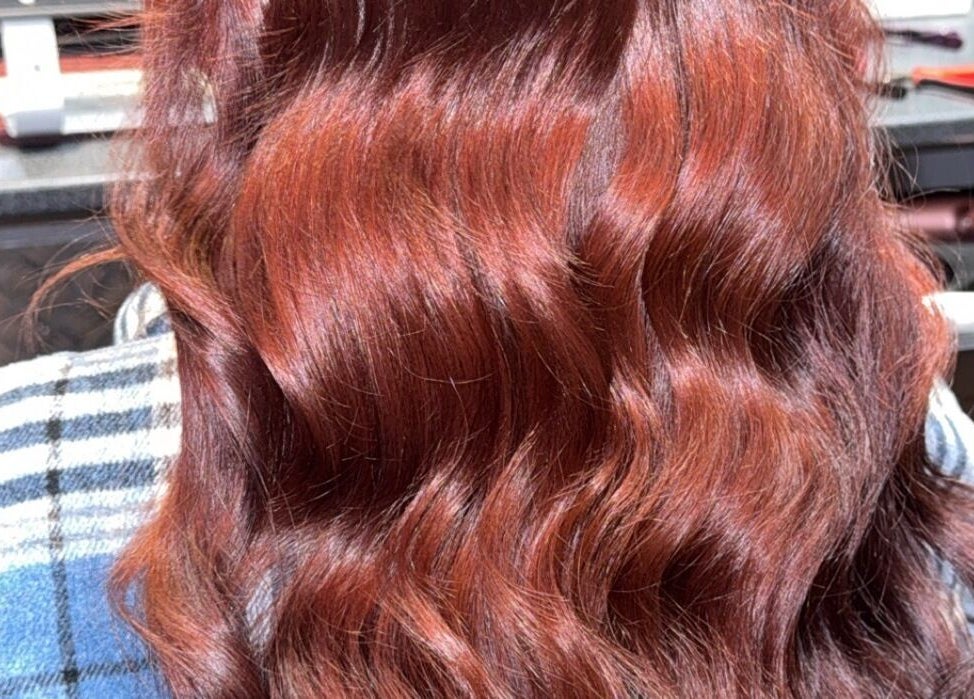 Vibrant red hair waves styled at Colour Queen in Scunthorpe, England, GB.