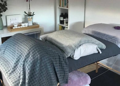 Tranquil massage setup at The Relaxation Room Leixlip, County Kildare, IE, featuring plush bedding and calming decor.